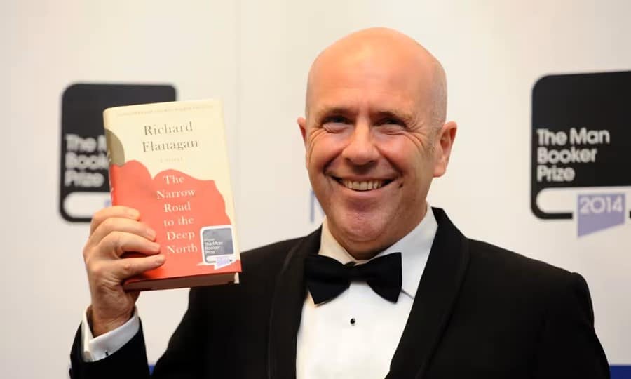 Richard Flanagan holding his book The Narrow Road to the Deep North