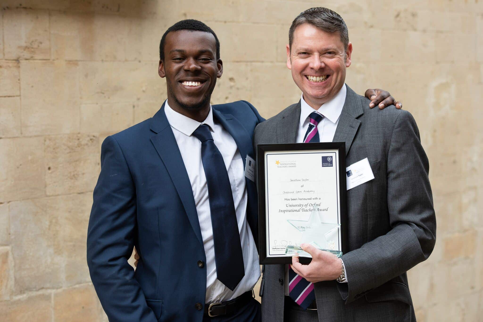 Ephraim Conteh and Jonathan Taylor holding framed certificate