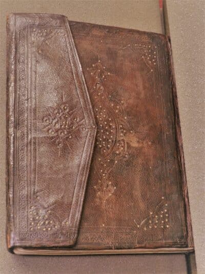 Photograph of wraparound binding, goat, with blind and gilt tooling.