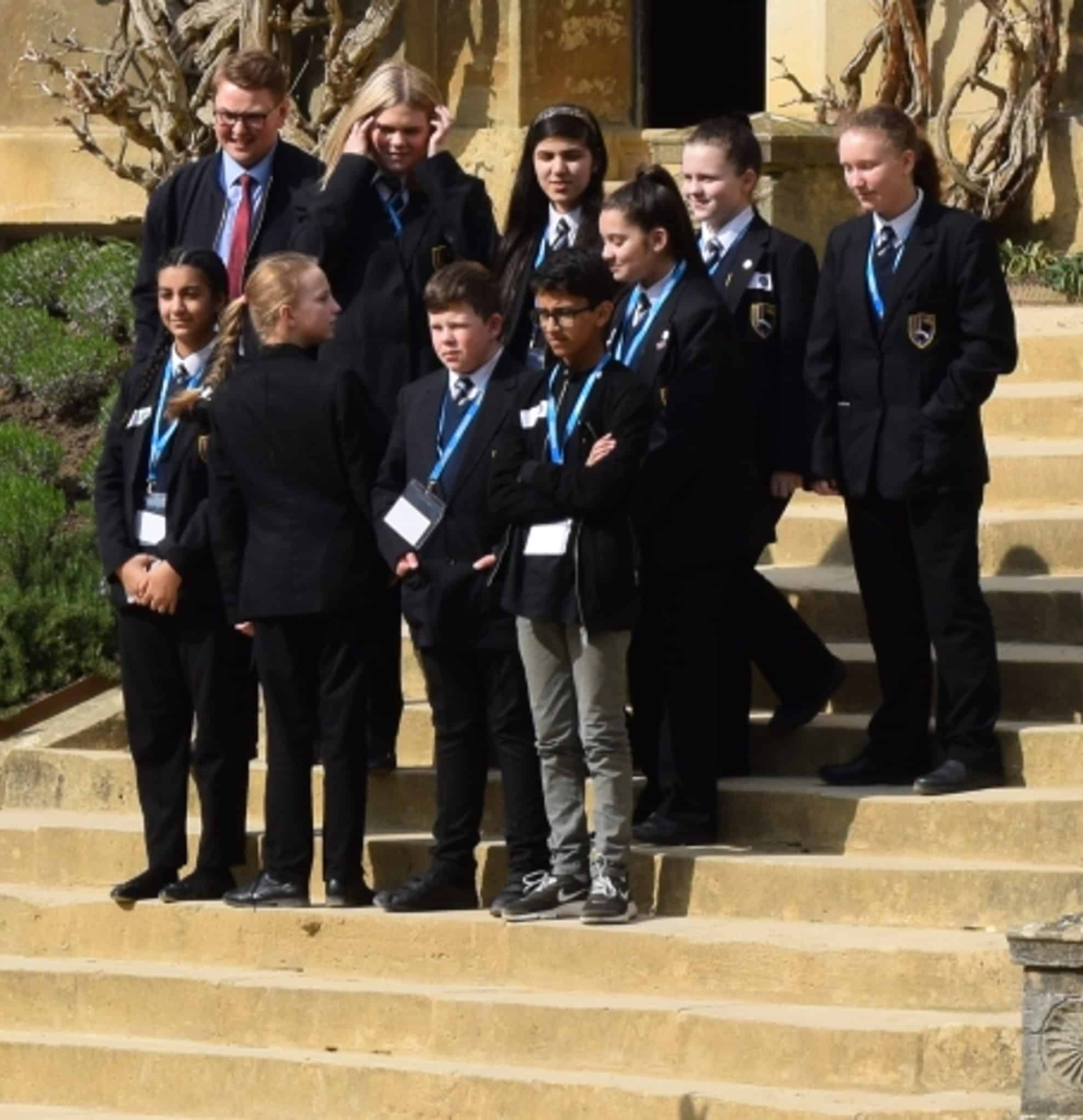 School pupils stood on quad steps