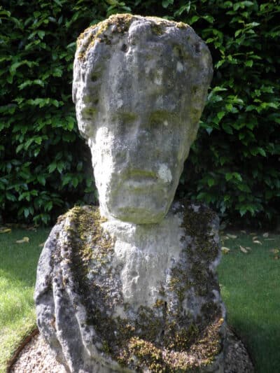 Image of weathered stone head in Worcester College Gardens.