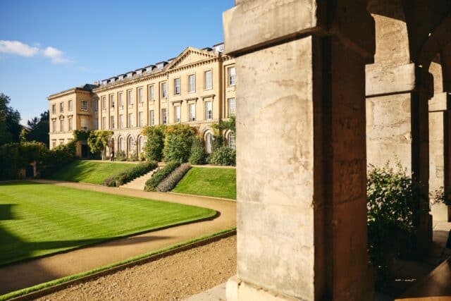 Main quad buildings and lawn seen from behind columns