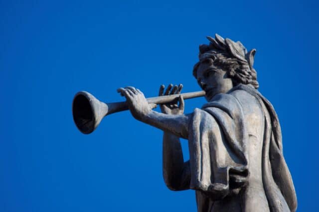 Statue of Greek muse playing horn