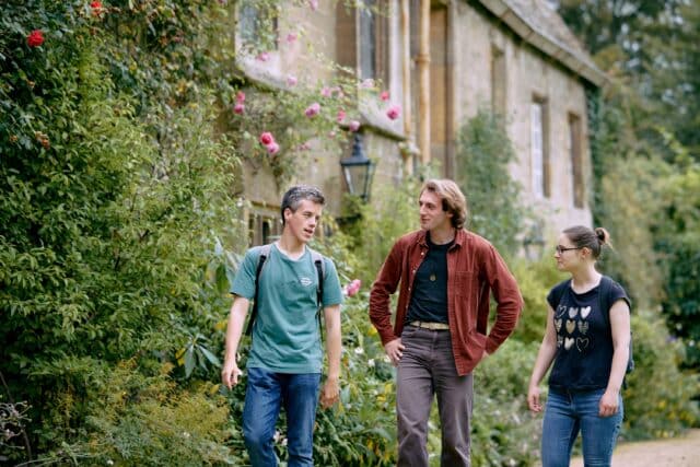 Students walking in front of cottages