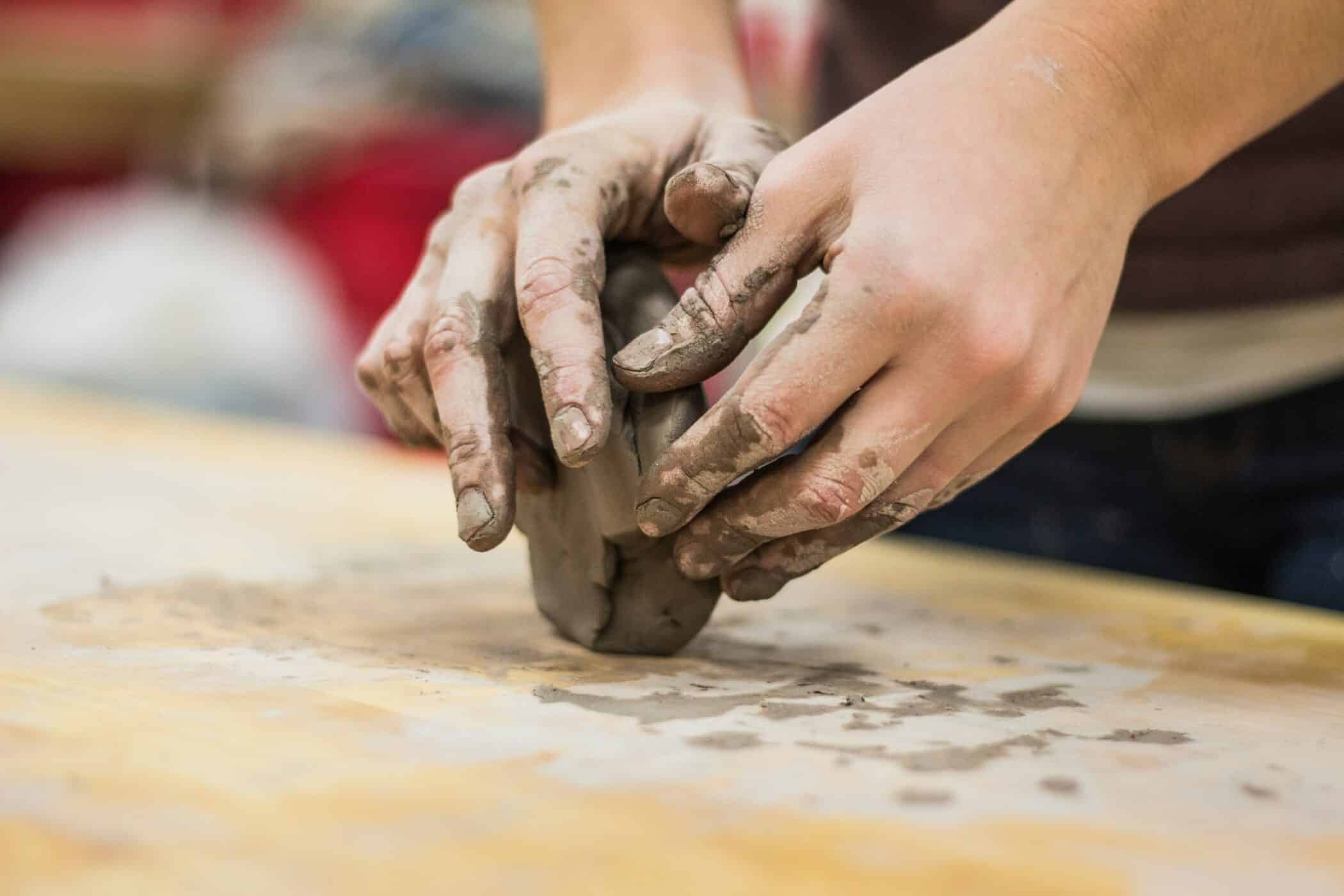 Hands shaping clay