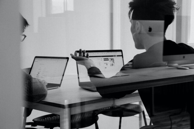 Two people meeting with laptops