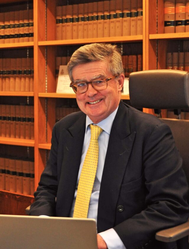 Sir Julian Flaux at his desk