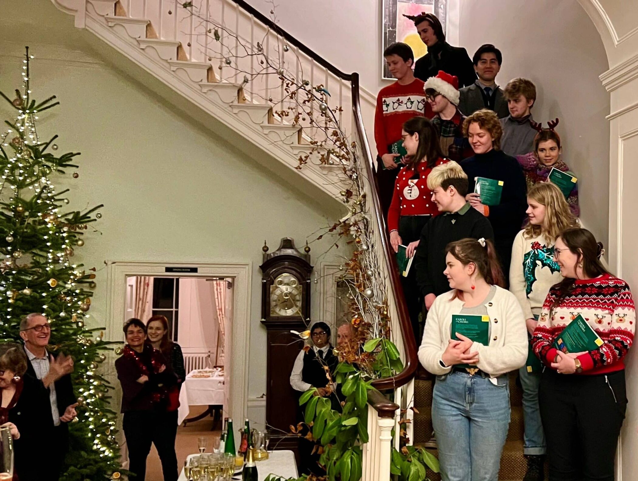 College choir singing carols on a staircase