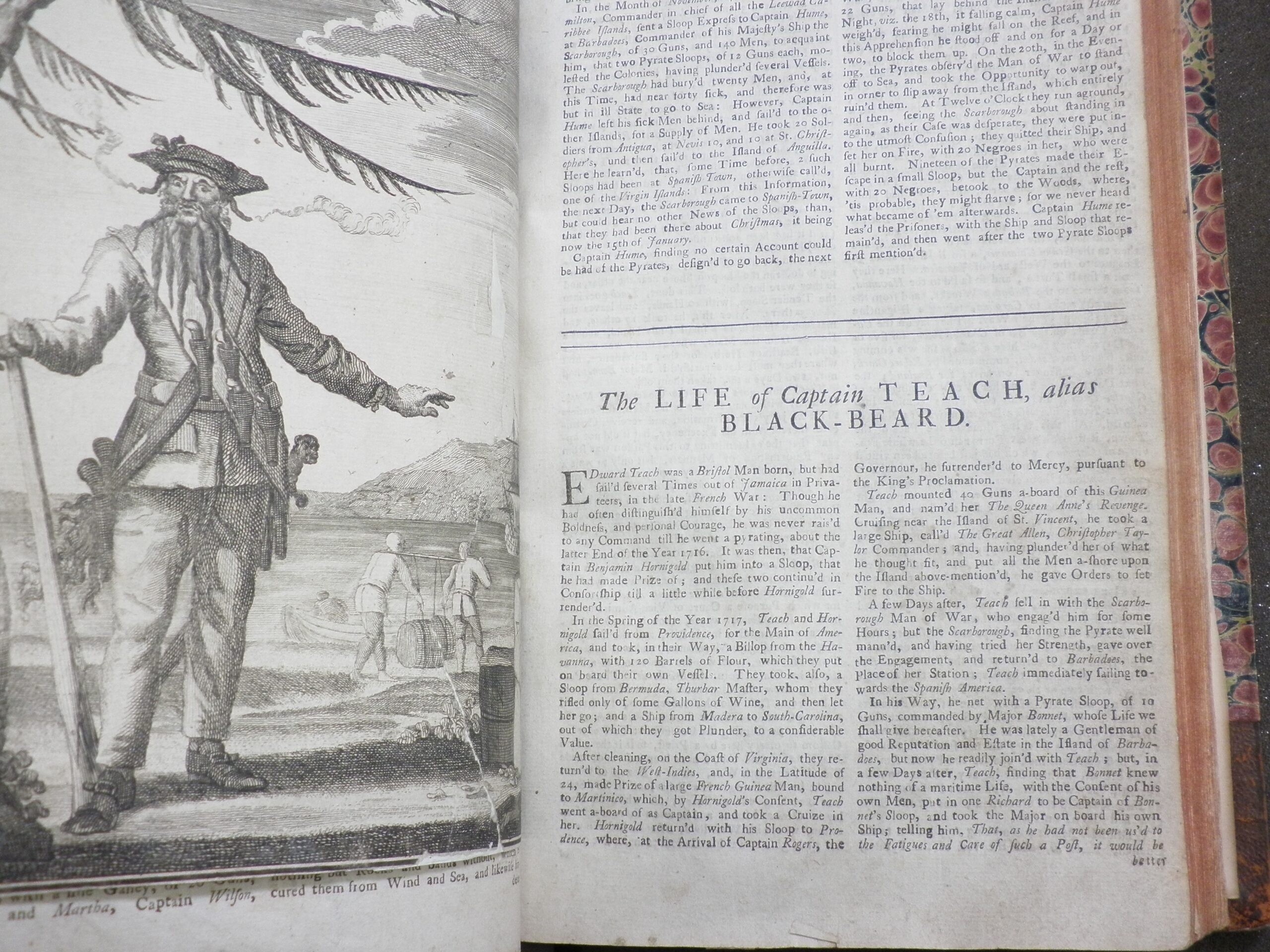 Photograph of the first page of the Life of Captain Teach, alias Black-Beard, illustrated with an engraved image of Blackbeard on a beach.