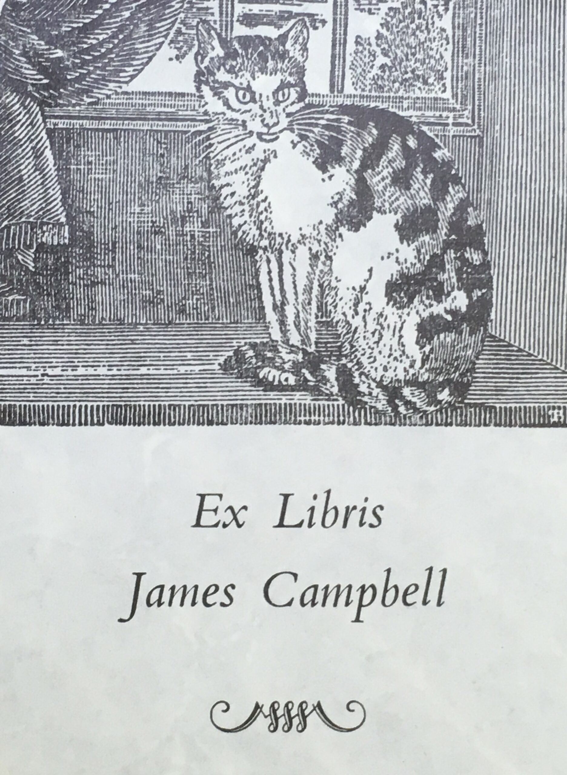Image of a bookplate. The top half is a black and white drawing of a cat, the bottom half reads 'Ex Libris James Campbell'.