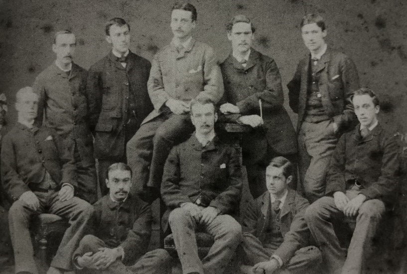 A black and white photograph of a group of 10 young men in 1895.