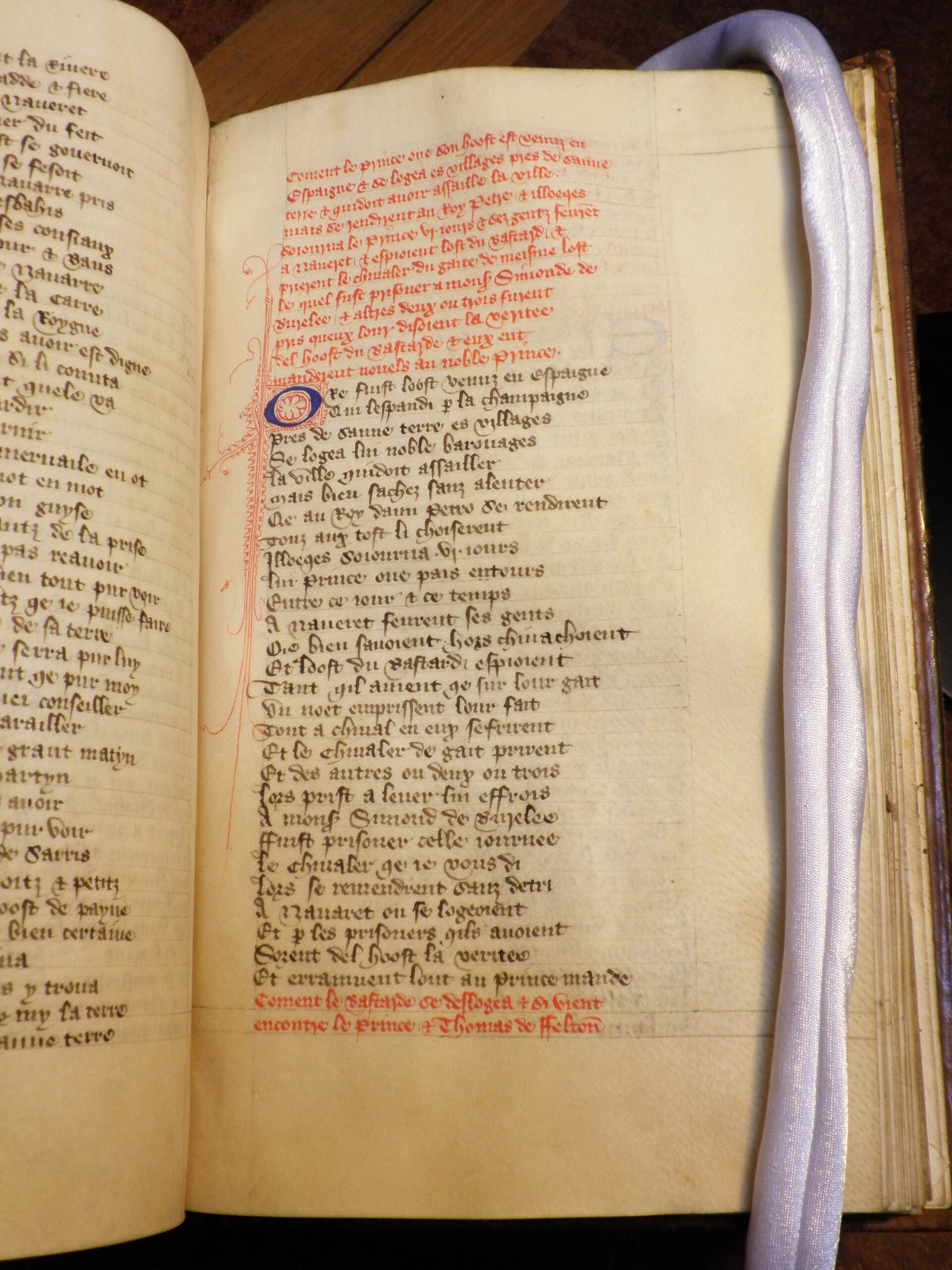 Page of manuscript. Text in red and black. One small illuminated capital and illumination in red ink in margins.