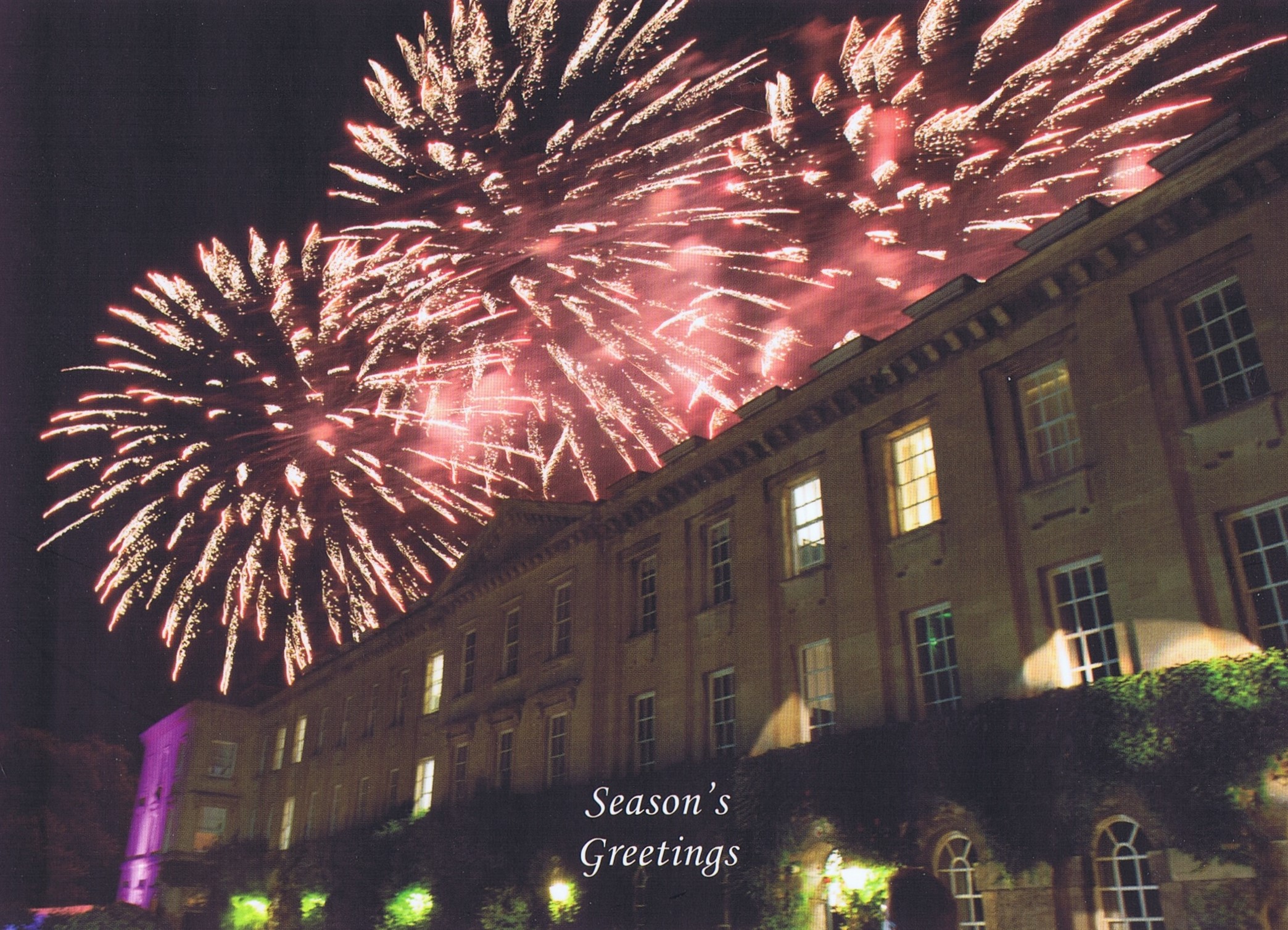 Photograph of the eighteenth-century terrace of the College, taken at the Commemoration Ball of 2014. Pink fireworks light up the sky behind the terrace.