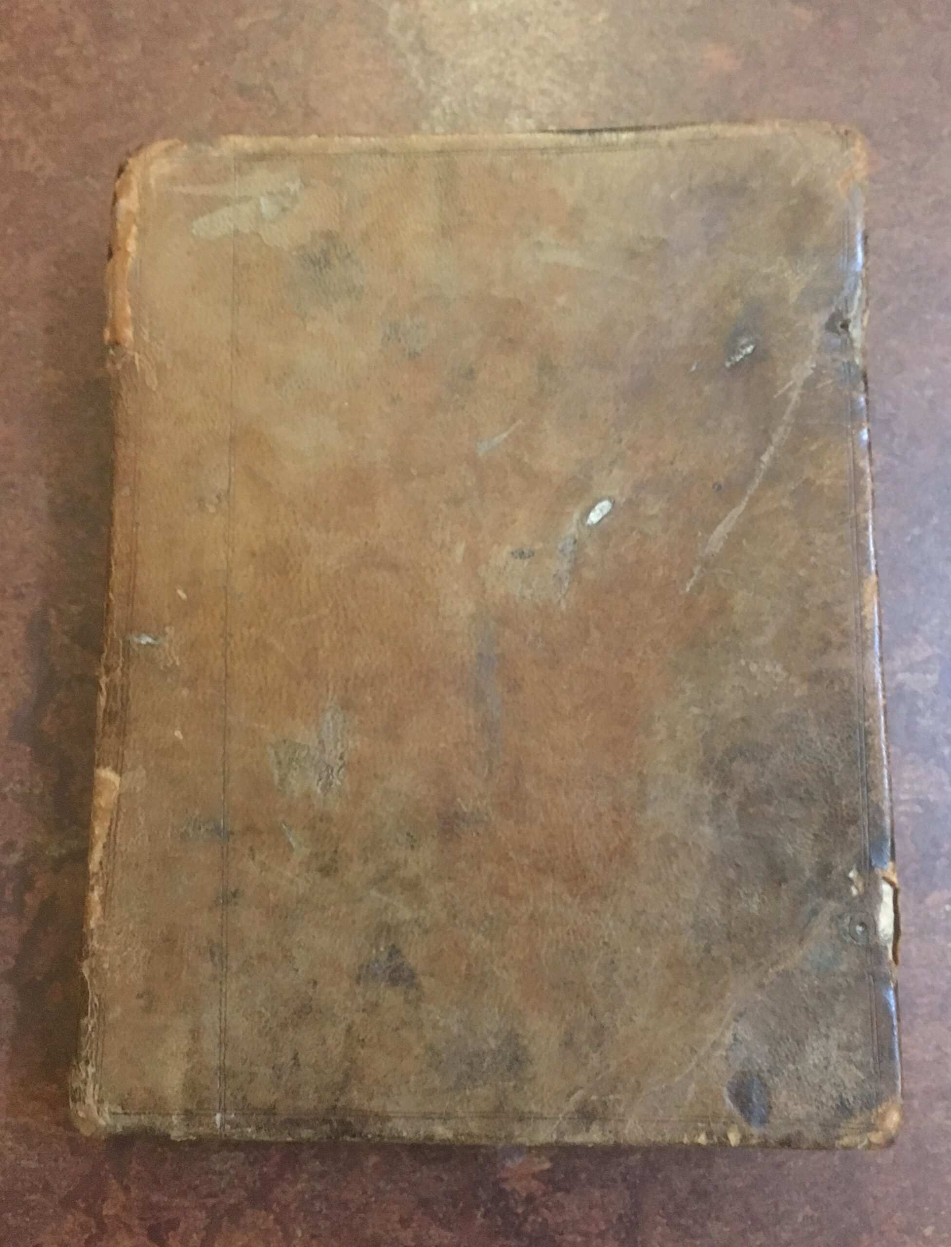 Photograph of one of William Clark's original notebooks, which has a worn plain leather binding.