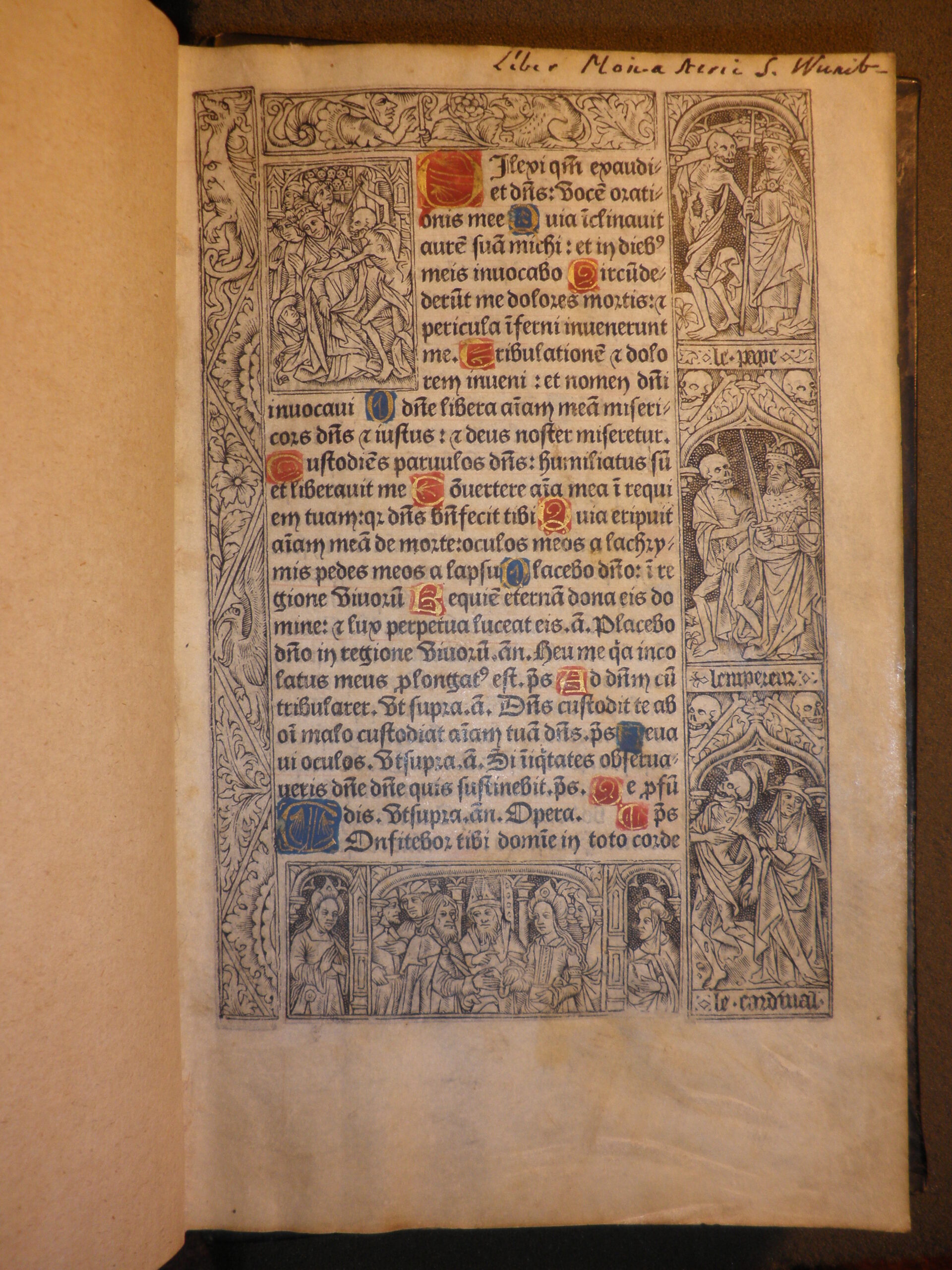 First page of the Office of the Dead. The text is in gothic typeface with illuminated capitals, and is framed with woodcuts depicting prominent figures meeting Death in the form of a skeleton..