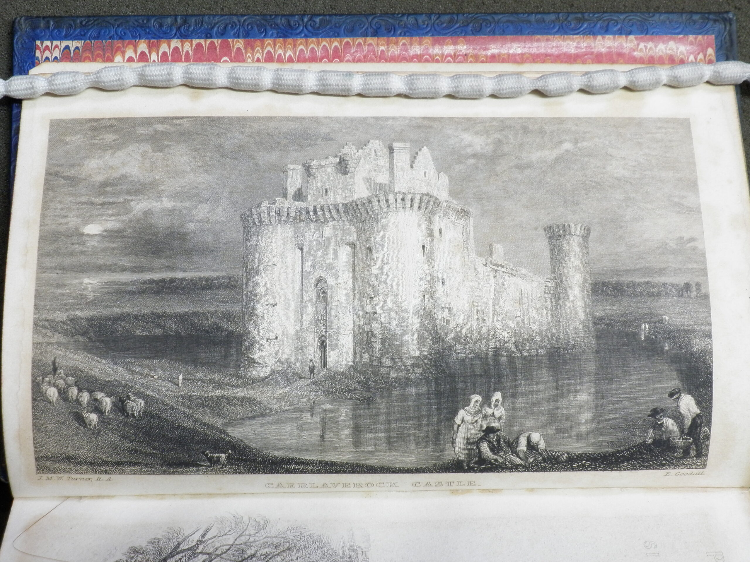 Black and white engraving of Caerlaverock Castle. It is surrounded by a lake, with peasants and sheep in the foreground.