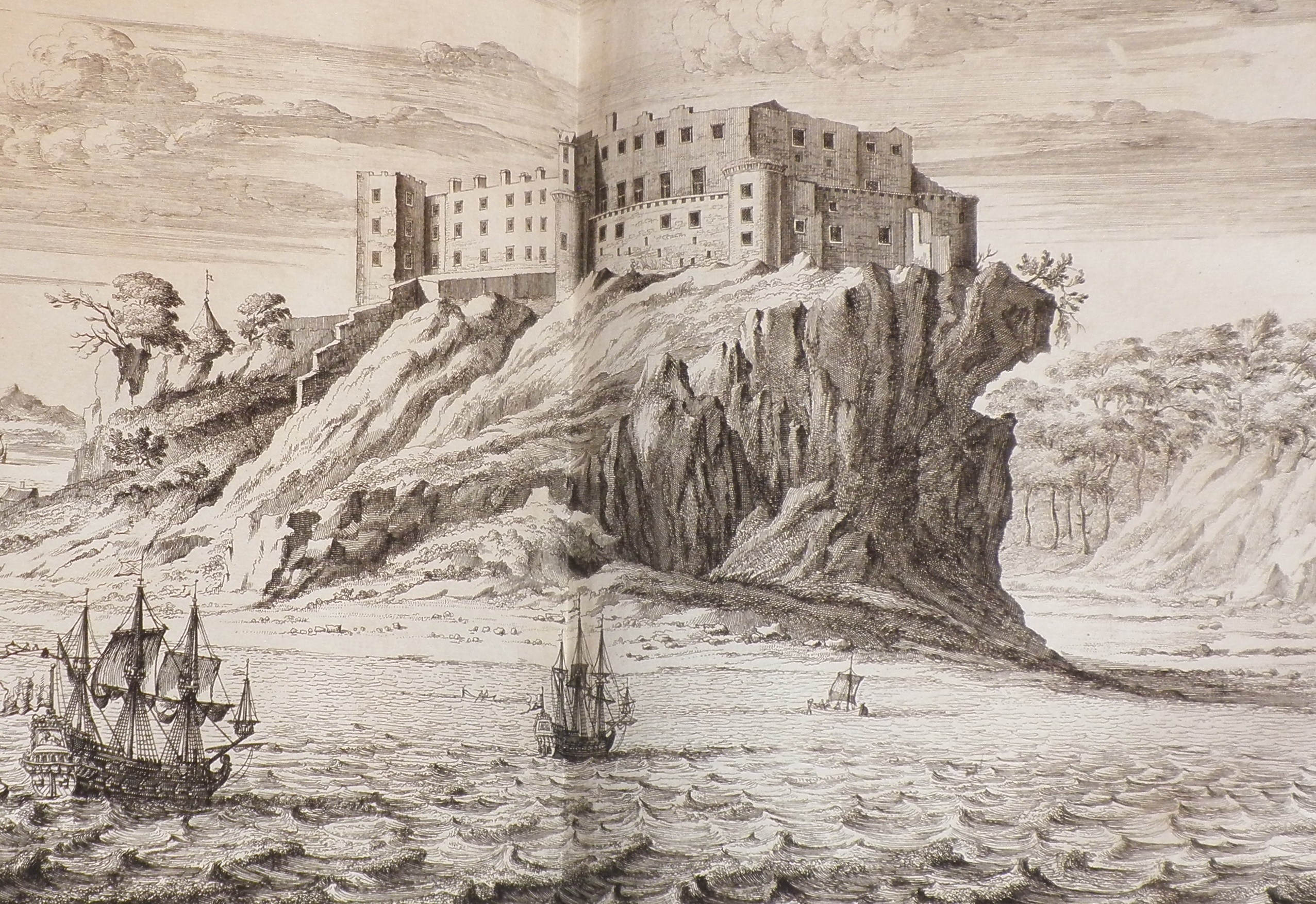Black and white engraving of Dunnottar Castle, which is atop a rock rising dramatically out of the sea.