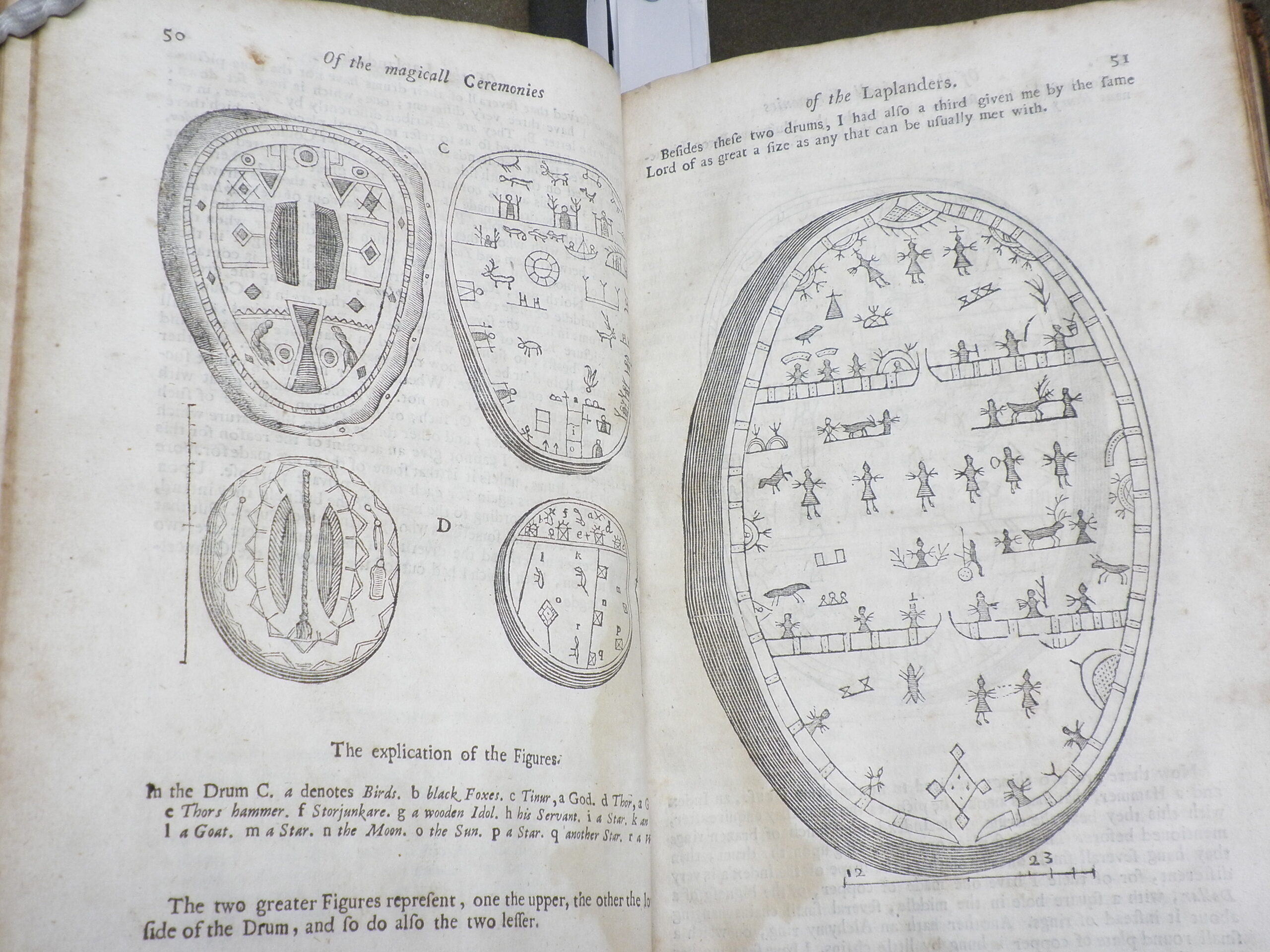 Woodcut illustrations of several drums, which are decorated with a variety of designs.