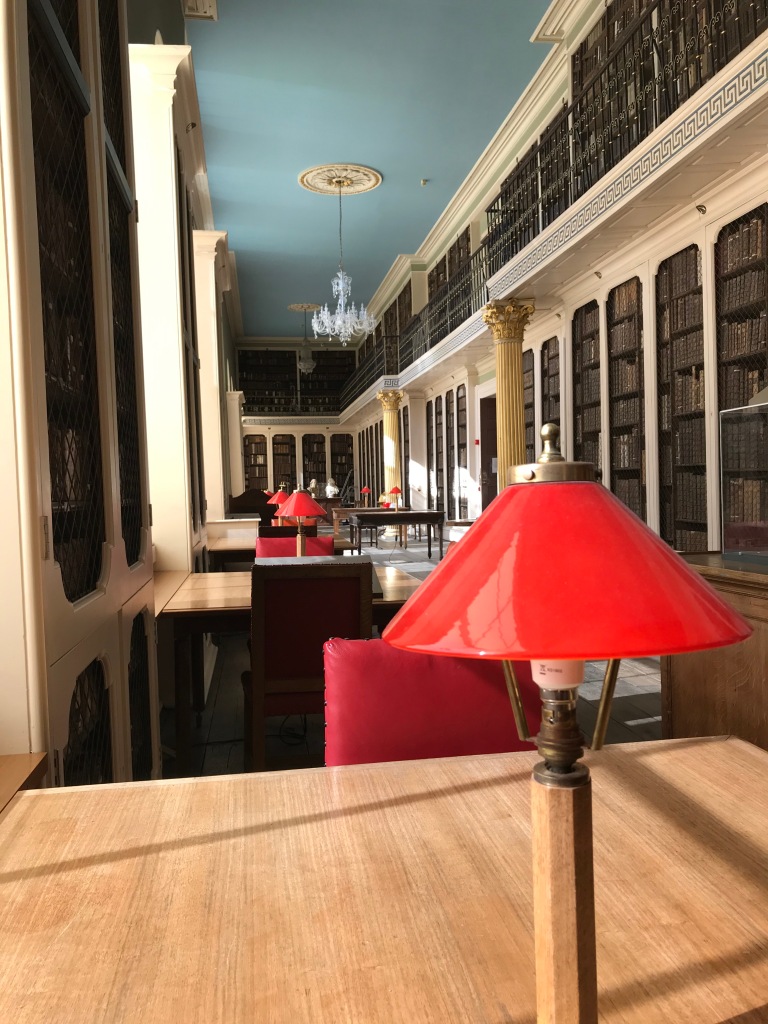 The Lower Library interior seen from the south with a red reading lamp in the foreground.