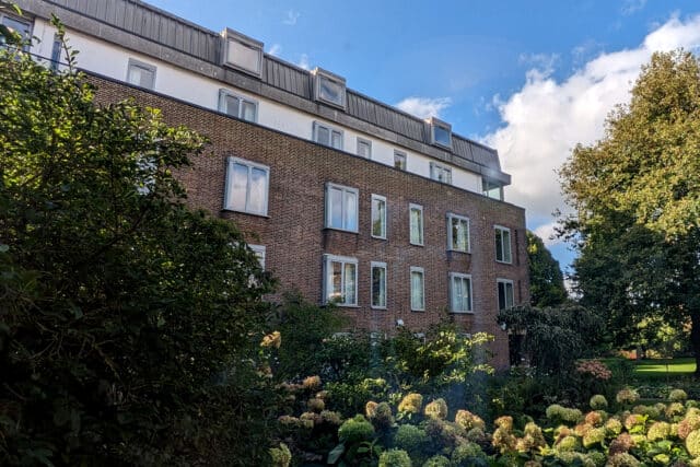 Casson Building surrounded by trees and plants