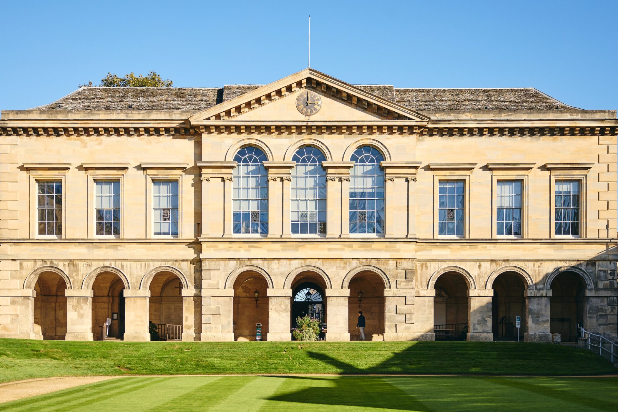 Stone library building with lawn