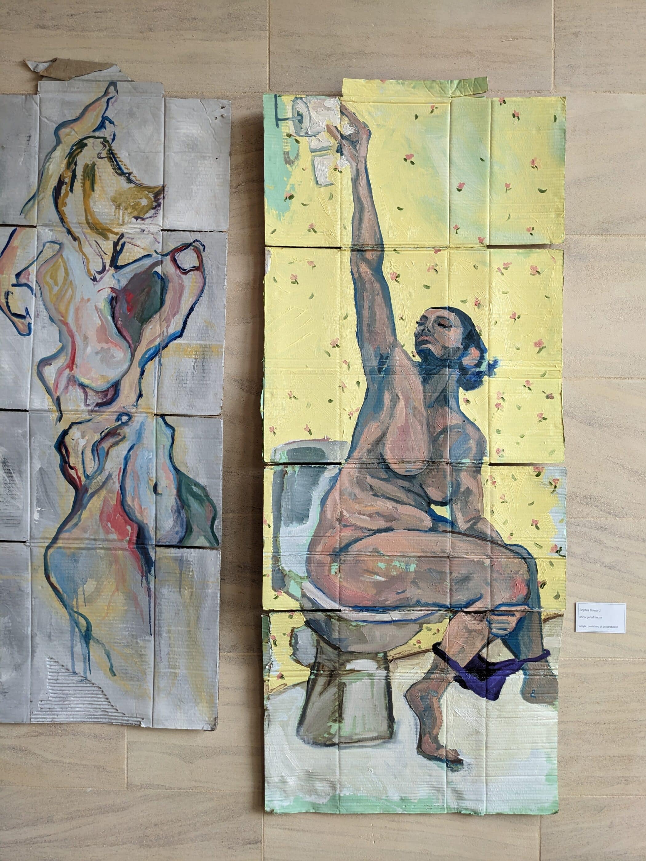 Two paintings of nude women on cardboard affixed to stone wall