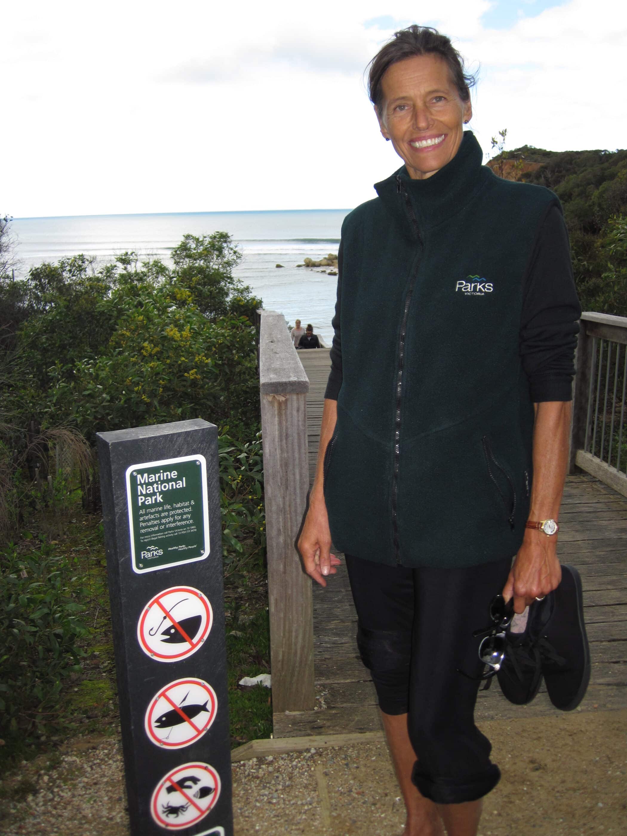 Tundi Agardy on boardwalk next to sign for Marine National Park