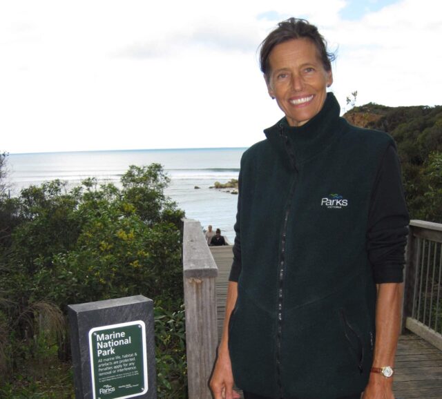 Tundi Agardy on boardwalk next to sign for Marine National Park