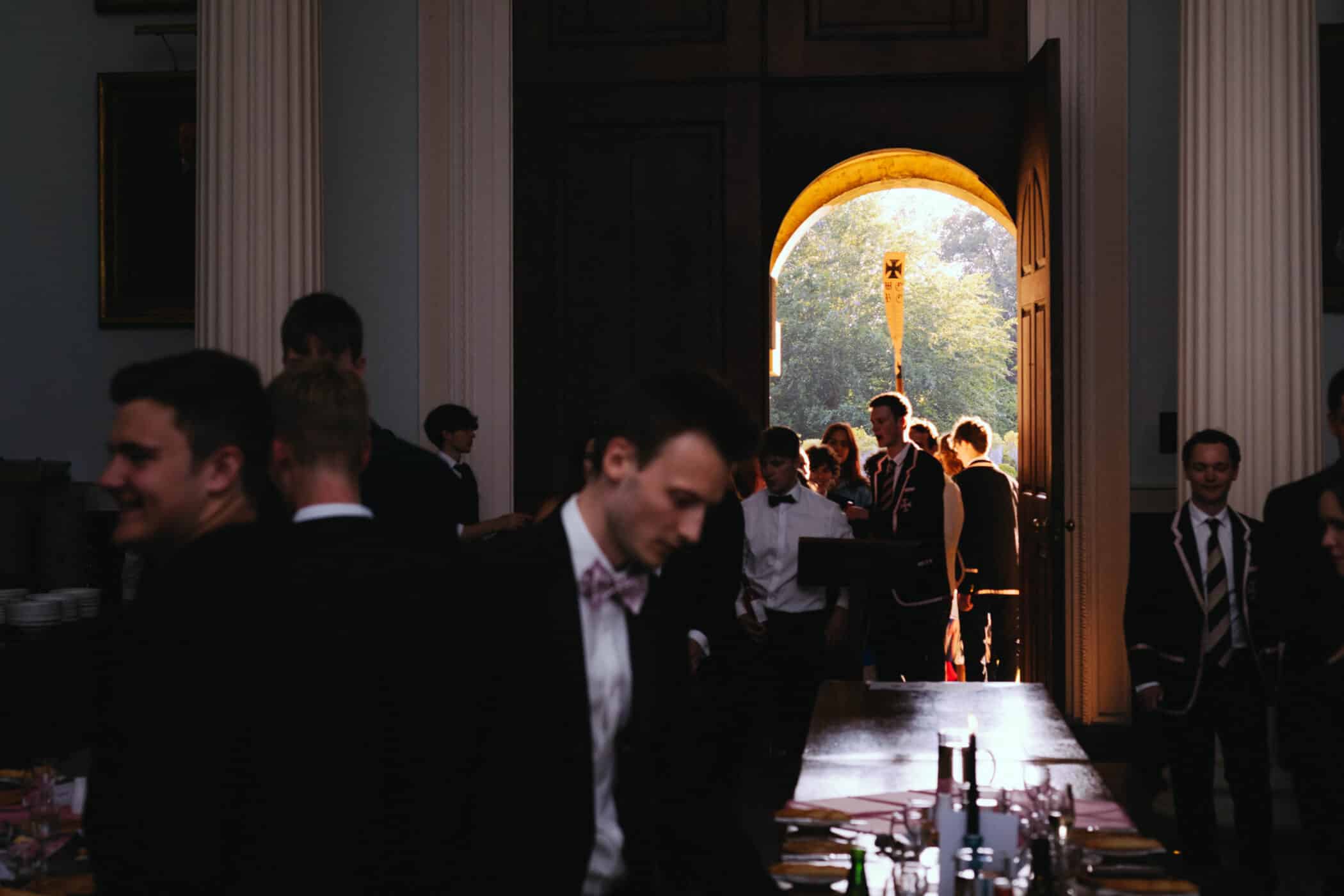 Oar being carried through the door into the dining hall