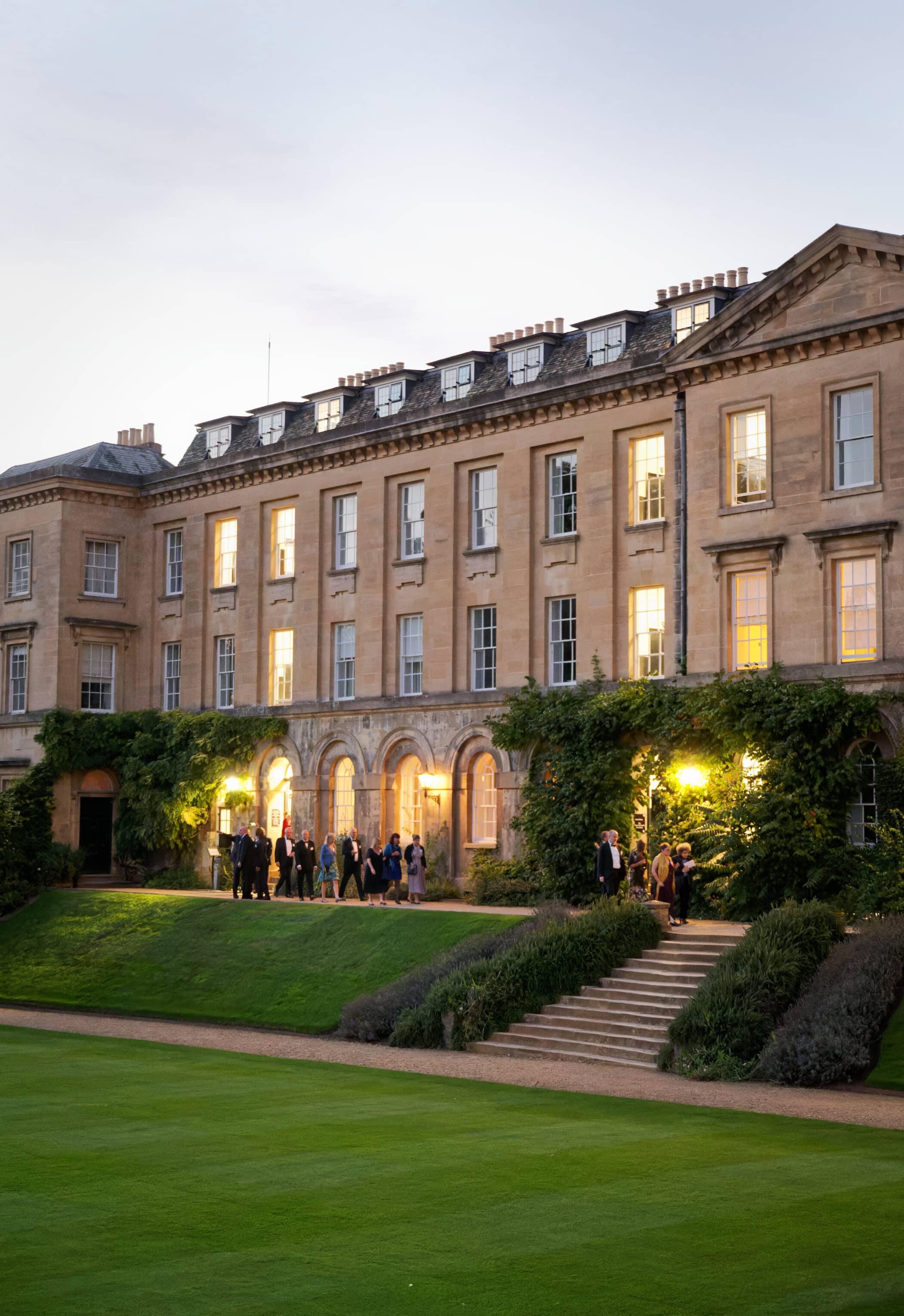 Alumni walking in the Main Quad at twilight