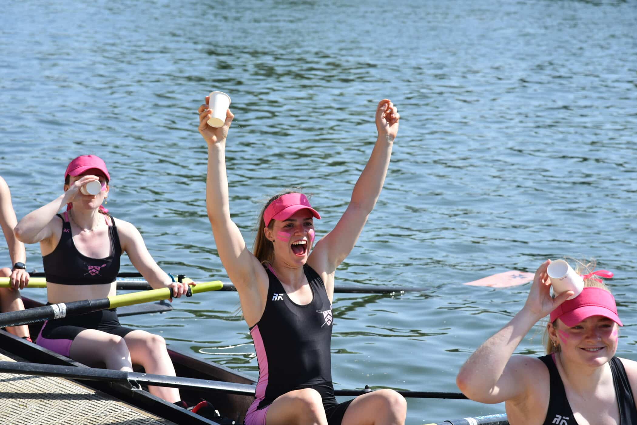 Rower with her arms in the air