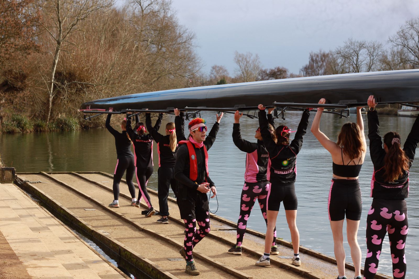Rowers holding a boat above their heads