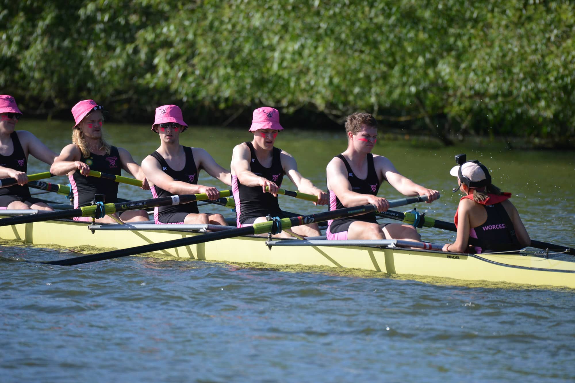 Rowers in pink bucket hats