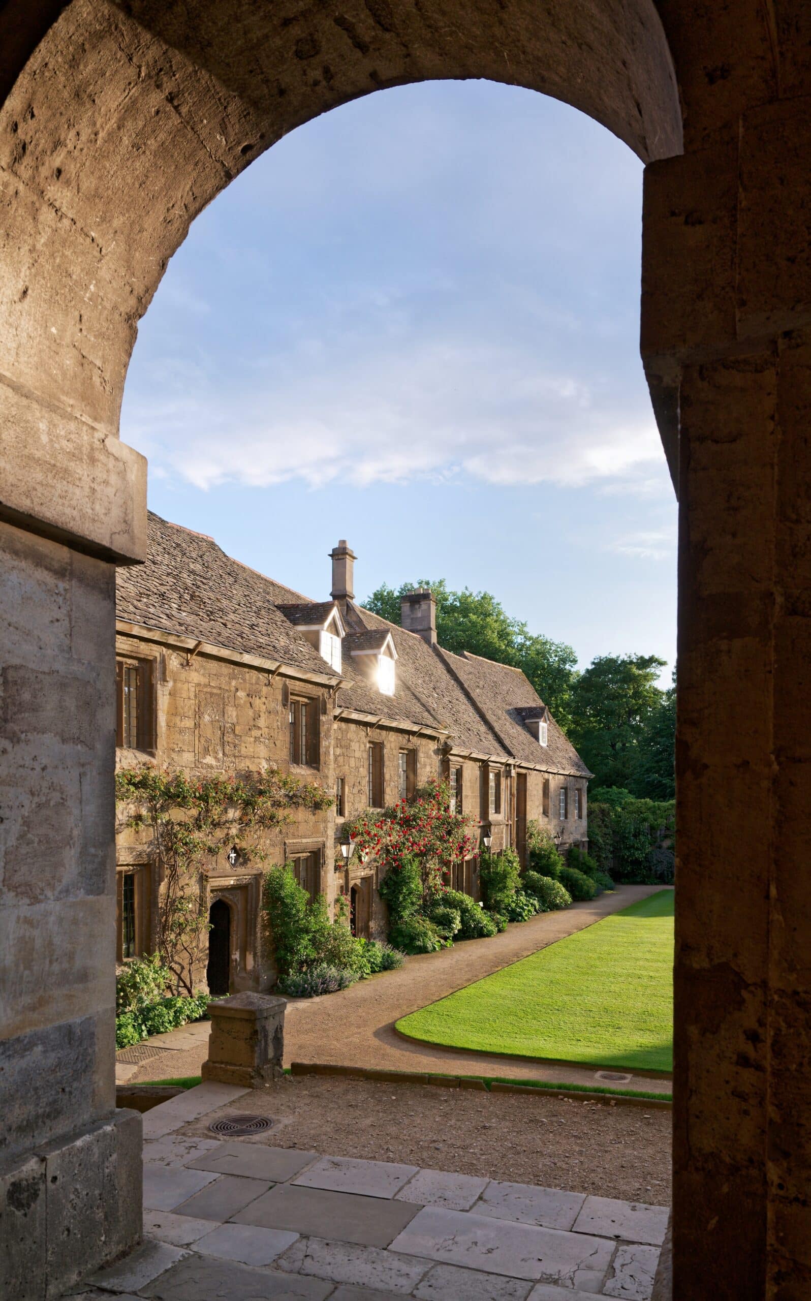 Cottages and lawn seen through stone arch