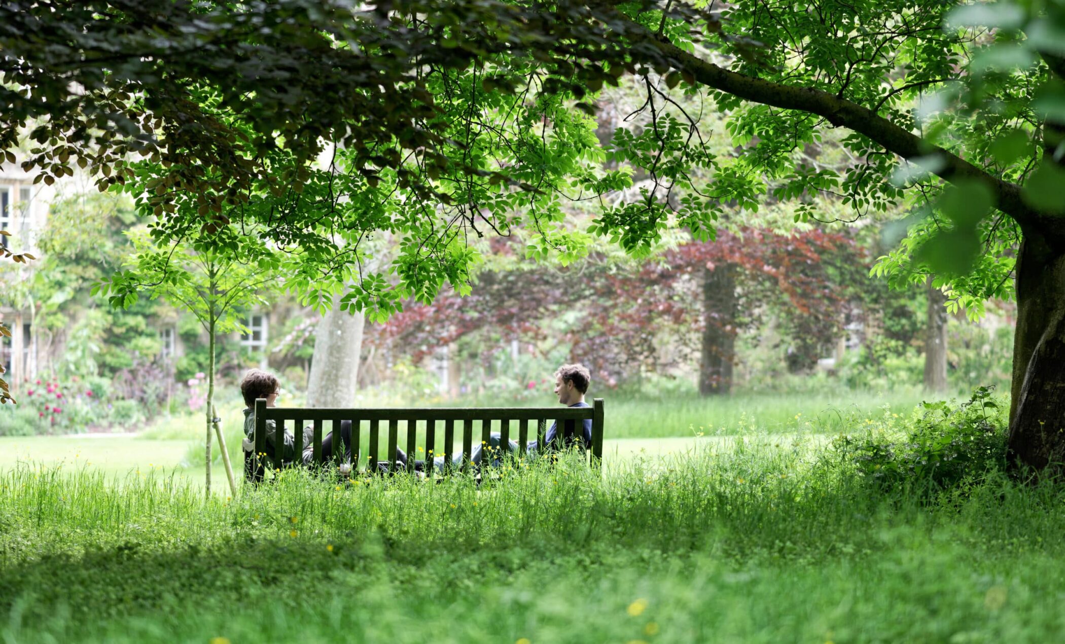 Two students chatting on a bench