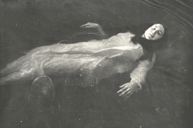 Woman floating on surface of lake