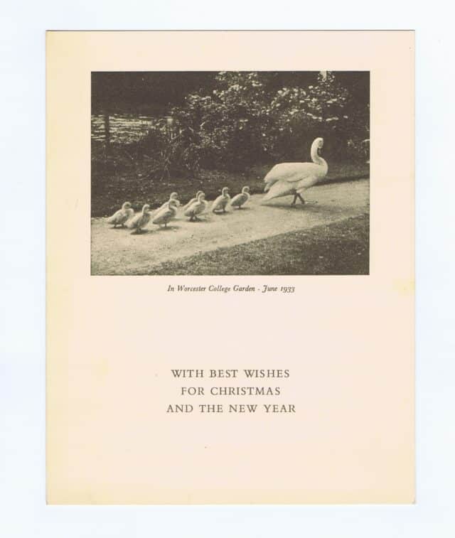 Christmas card with black and white photograph of swan followed by cygnets