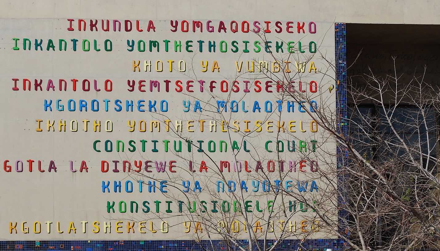 Exterior of Constitutional Court of South Africa with multi-coloured lettering in multiple languages