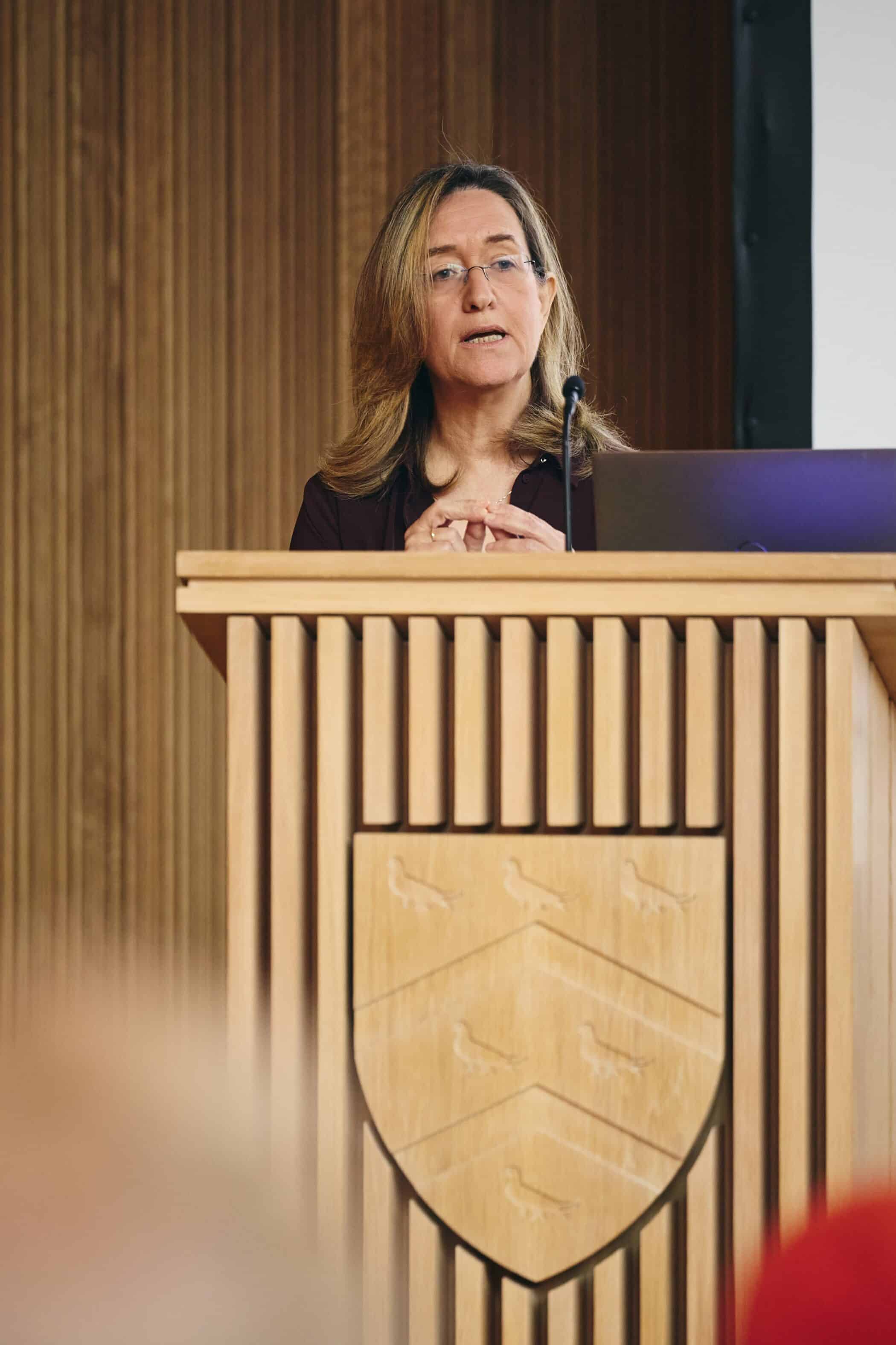 Ilana Dayan speaking at lectern