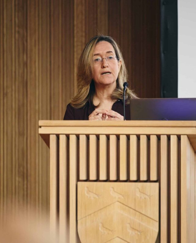 Ilana Dayan speaking at lectern