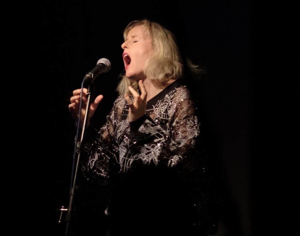 Jennifer Walshe singing at a microphone