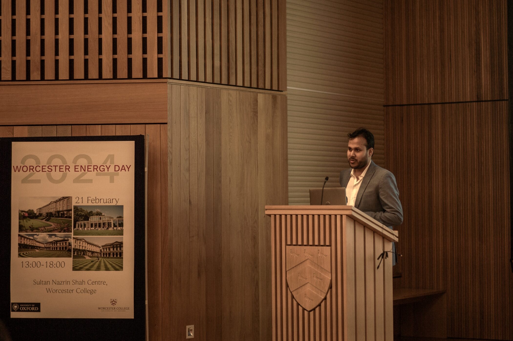 Krishanu Dey speaking at podium