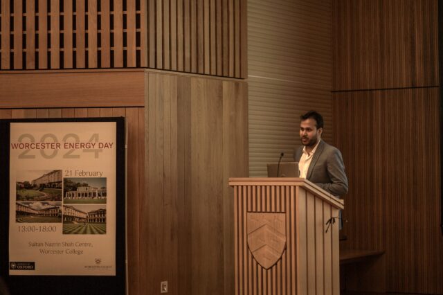Krishanu Dey speaking at podium