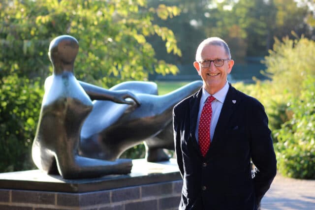 David Isaac with Henry Moore's Reclining Figure, 1982