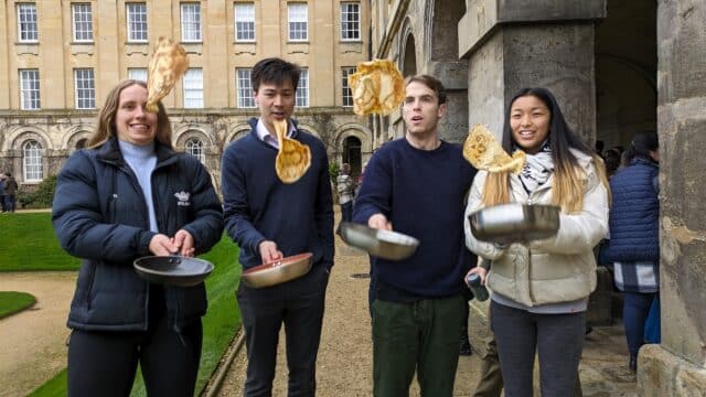 Four people flipping pancakes