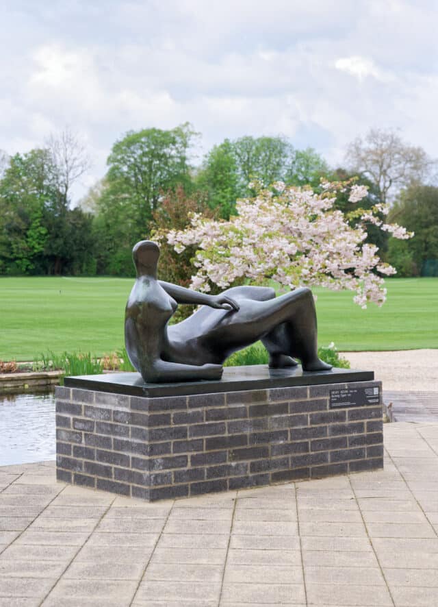 Henry Moore's Reclining Figure in front of blossom tree
