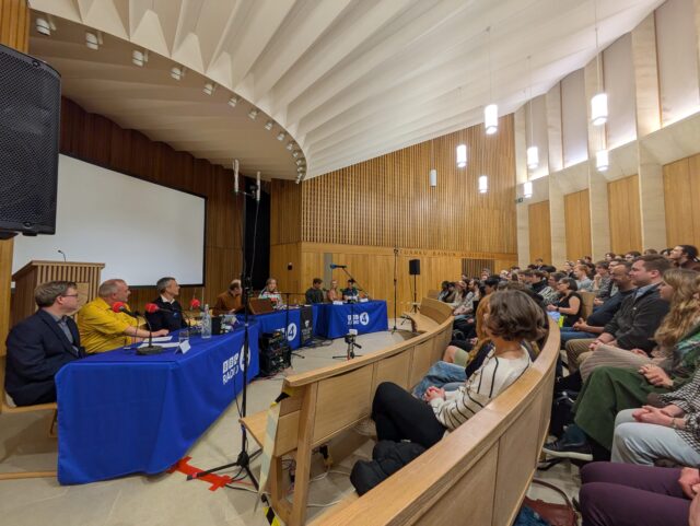 Radio recording with panelists and audience in auditorium