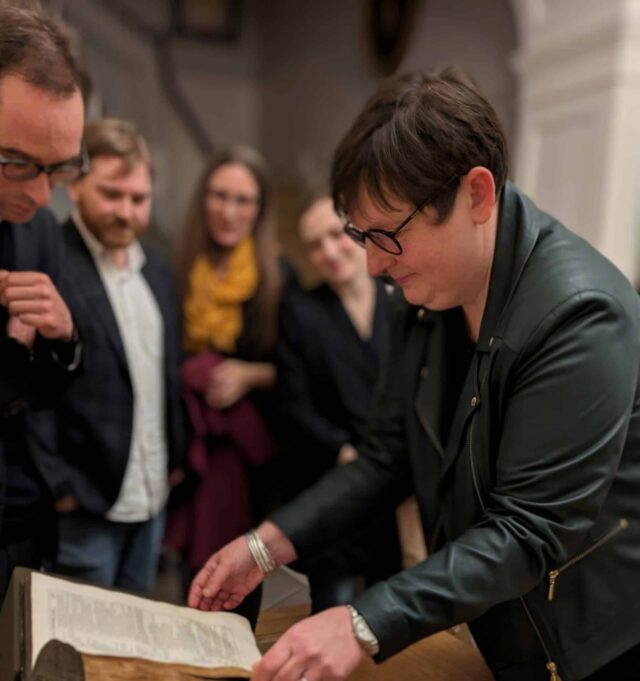 Emma Smith leafing through Shakespeare Folio