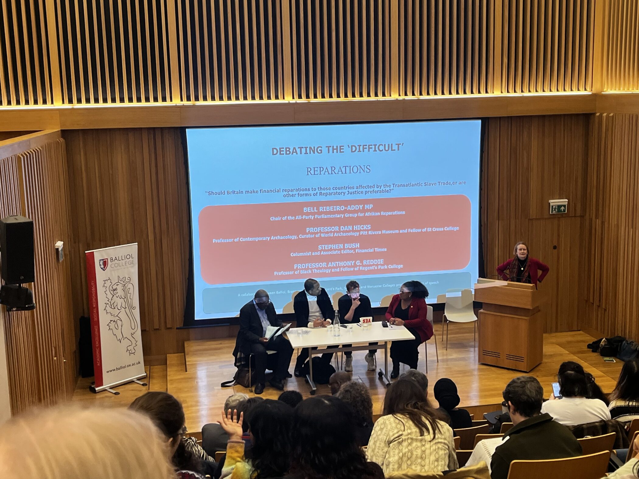 Debate speakers in front of audience