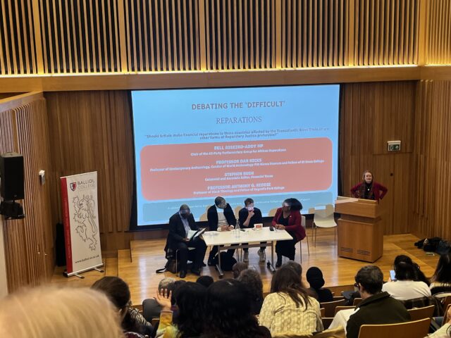 Debate speakers in front of audience